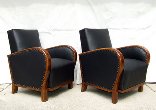 Art Deco black leather armchairs.